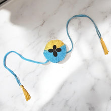 Load image into Gallery viewer, Premium 2-Colour Plantable Thread Rakhi with Torai Seeds & Roli Chawal – Pastel Yellow & Blue – Eco-Friendly Rakhi for Raksha Bandhan